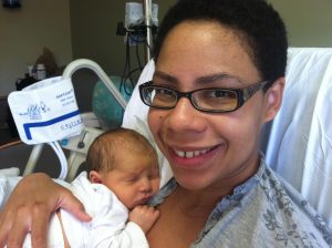 Image: A new mom holding her newborn baby