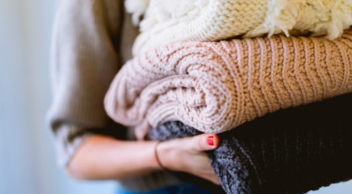 Donate in Miami: 10 Causes to Support With Your KonMari Items Image: A woman holds of stack of knitted sweaters