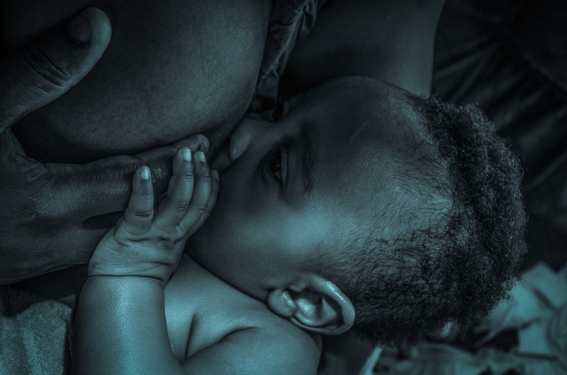 Image: A Black mother breastfeeding her infant