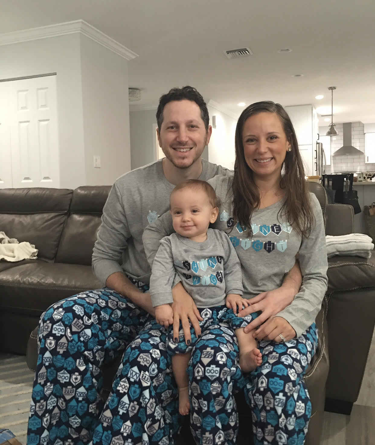 Image: A family poses for a photo with matching Hanukkah PJs