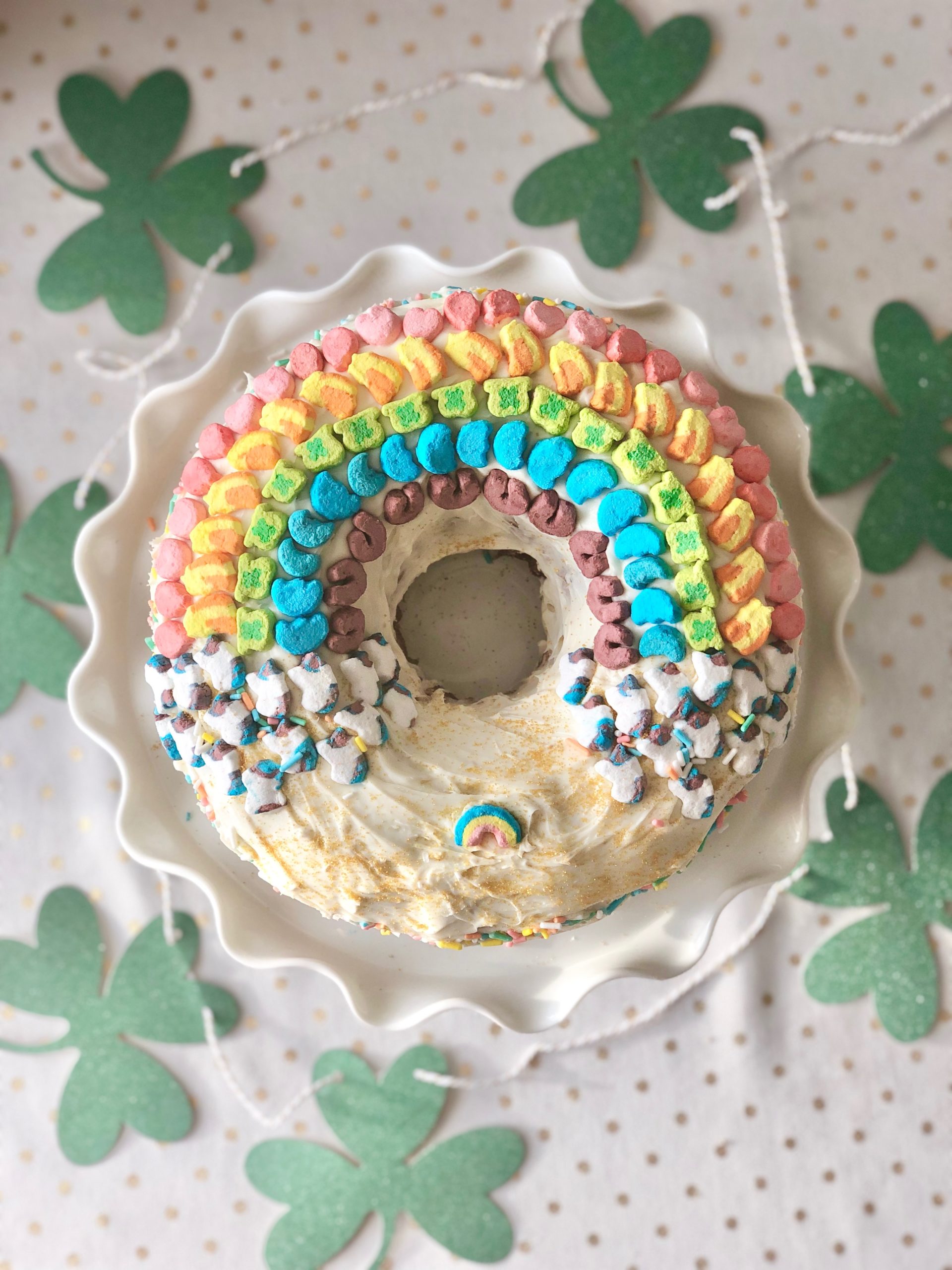 Image: A festive bundt cake decorated with a rainbow made of Lucky Charms