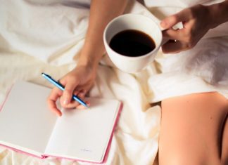 Image: A woman writing in a gratitude journal with a cup of coffee