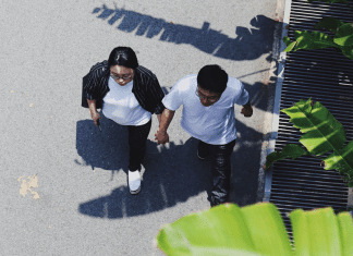 A couple holding hands and going for a walk (Creative Date Night Ideas on a Budget Becky Gonzalez Contributor Miami Mom Collective)