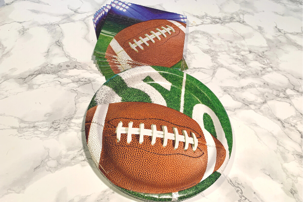 Festive football plates and napkins (The Big Game: Quick Recipes and Tips for a Super Fun Day Ana-Sofia DuLaney Contributor Miami Mom Collective)