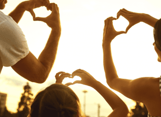 A family making hearts with their hands (Love Where You Live: Why I Love Living in Hialeah Lorena Lougedo Contributor Miami Mom Collective)