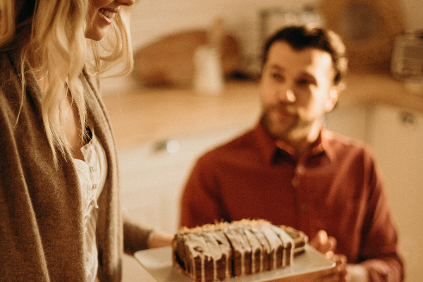 A couple celebrating with cake (Husband Appreciation Day: Celebrate the Hubbies Lorena Lougedo Contributor Miami Mom Collective)
