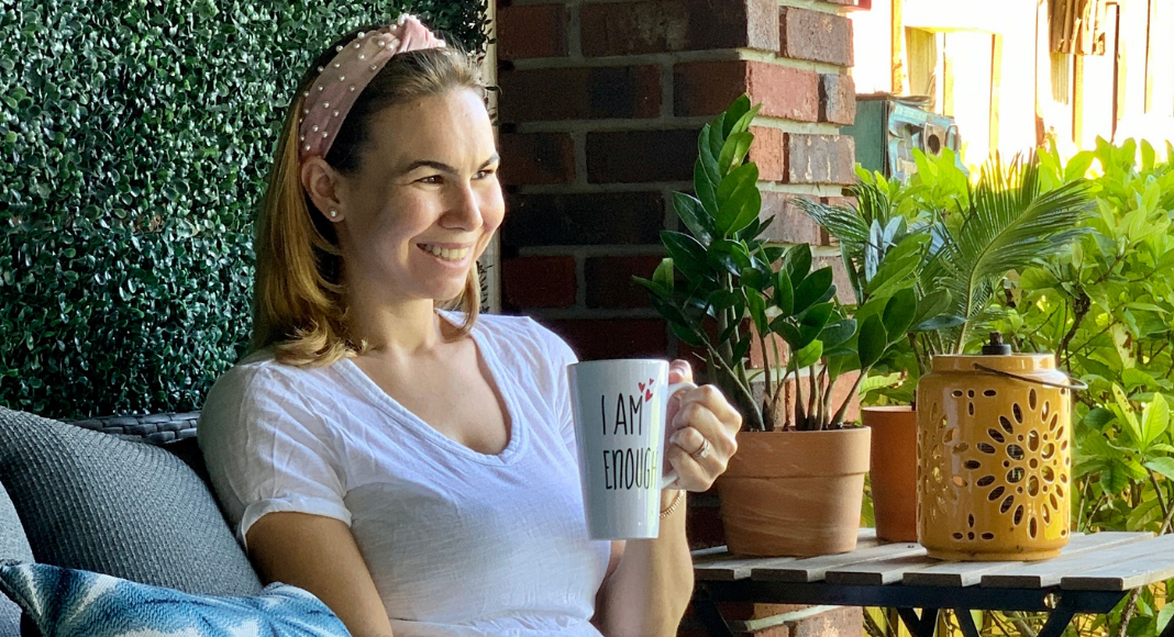 Jessica sitting with a cup of coffee (Miami Mom Collective Welcomes MIA Mom Jessica Socarras Contributor)