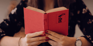 Let’s Celebrate: National Reading Across America Day A woman holding an open book (Let's Celebrate: National Reading Across America Day Lorena Lougedo Contributor Miami Mom Collective)