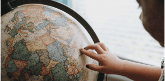 Tooth Fairy Traditions From Around The World | Dr. Bob Pediatric Dentist A little girl looking at a globe (Tooth Fairy Traditions From Around The World | Dr. Bob Pediatric Dentist Lynda Lantz Contributor Miami Mom Collective)