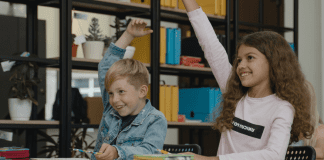 School Involvement: 3 Ways to Help Your Student Succeed Two students raising their hands (Get Involved: 3 Ways to Help Your Student Succeed Ailyn Quesada Contributor Miami Mom Collective)