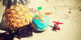 Fighting Summer Boredom Sunglasses, a pineapple, a toy airplane, and a globe (Fighting Summer Boredom Lorena Lougedo Contributor Miami Mom Collective)