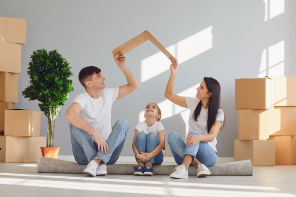 Image: A father and mother sitting on the floor with their daughter, surrounded by moving boxes (Moving with Children: 4 Helpful Tips Jessica Socarras Contributor Miami Mom Collective)