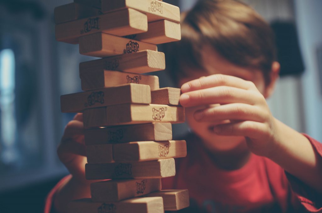 A kid playing Jenga (Fun Without Your Phone (Except to Take Amazing Photos and Videos) Janeris Marte Contributor Miami Mom Collective)