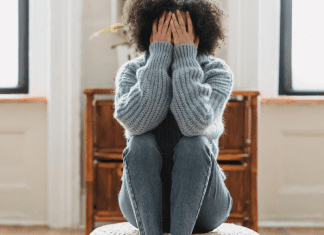 Speak Up: You Matter, Your Opinions Matter Image: A woman sitting down with her head in her hands (Speak Up: You Matter, Your Opinions Matter Rachelle Haime Contributor Miami Mom Collective)