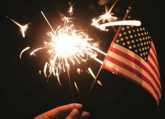 A sparkler and an American Flag (Fireworks: What to Do and Where to See Them in Miami on the 4th of July Bella Behar Contributor Miami Mom Collective)