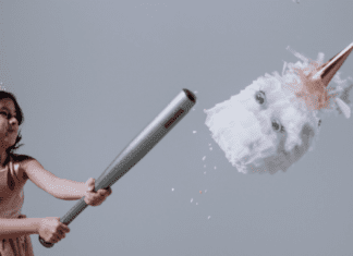 A girl hitting a pinata (Hispanic Heritage Month: Ways to Celebrate Lorena Lougedo Contributor Miami Mom Collective)