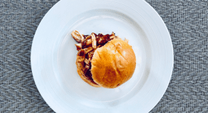 A plated BBQ chicken sandwich