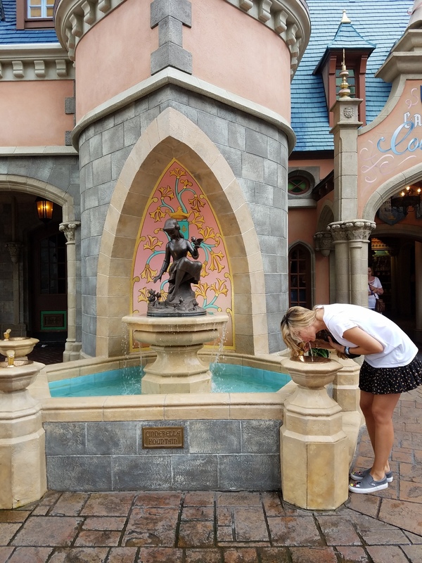 Disney Has Some Secrets, Sort Of - Sandra jacquemin Sandra taking a drink at Cinderella's fountain (Sandra Jacquemin Contributor Miami Mom Collective)