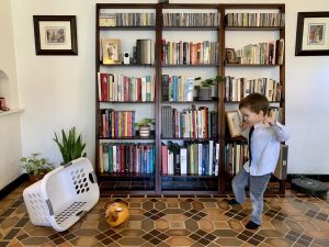 mage: A boy kicking a soccer ball into a laundry basket (Stuck Inside? Try These Gross Motor Games! Brittany Aquart Contributor Miami Mom Collective)