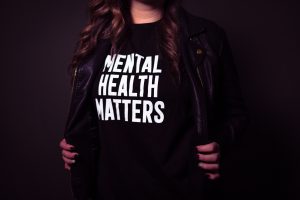Image: A woman wearing a shirt that says, "Mental Health Matters" (Mental Illness Awareness Week: Breaking the Stigma Becky Gonzalez Contributor Miami Mom Collective)