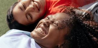 Image: Two multiethnic girls laughing and smiling together (Dental Hygiene Month: Brush Up on Oral Care | Dr. Bob Pediatric Dentist Lynda Lantz Contributor Miami Mom Collective)