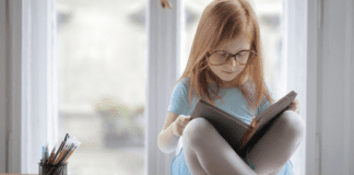 October is Dyslexia Awareness Month Image: A little girl reading a book (October is Dyslexia Awareness Month Sharonda Stewart Contributor Miami Mom Collective)