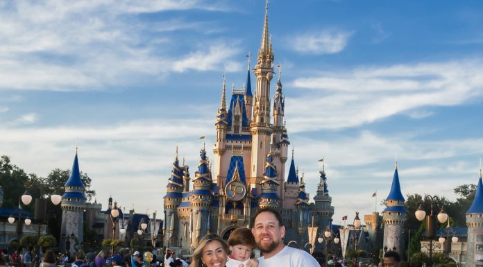 Image: Sandra with her husband and son in front of Cinderella's Castle at Disney (Disney at 50: Walt Disney World's Golden Birthday Celebration Sandra Jacquemin Contributor Miami Mom Collective)