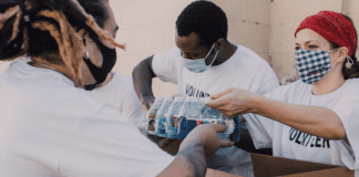 Image: Service volunteers packing aid boxes (Giving Tuesday 2021: A Global Effort to Bring the World Together Sharonda Stewart Contributor Miami Mom Collective)