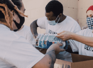 Image: Service volunteers packing aid boxes (Giving Tuesday 2021: A Global Effort to Bring the World Together Sharonda Stewart Contributor Miami Mom Collective)