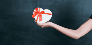 Image: An outstretched arm holding a gift box