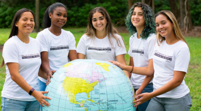 Image: A group of young women holding a large inflatable globe