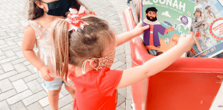 Image: A child donating a toy (Christmas: An Awesome Opportunity to Volunteer as a Family Holly Farver Contributor Miami Mom Collective)