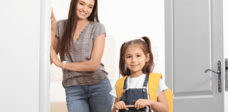 Image: A mom looks on as her daughter walks out the door, ready for school (School Mornings: 11 Hacks to Make Them Easy (Ok, "Easier") Candice Carricarte Contributor Miami Mom Collective)