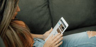 Image: Woman sitting and reading on her tablet (Top 10 Blog Posts of 2021 Lynda Lantz Editor Miami Mom Collective)