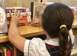 Image: A child looks for books at a local library