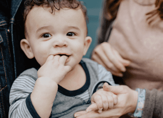 Families and transitions: A little boy, pictured with his parents, holding his mother's hand