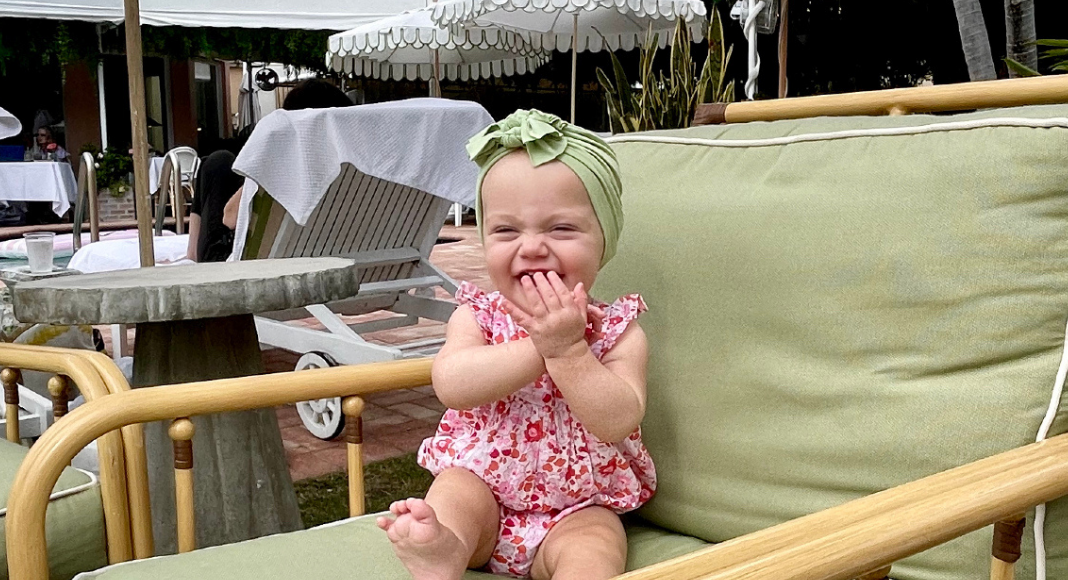 Monroe, smiling for the camera in a big beach chair