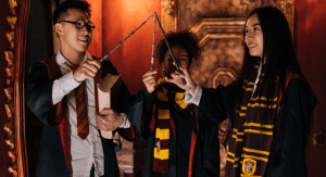 Three children dressed in Harry Potter costumes