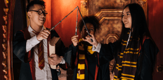 Three children dressed in Harry Potter costumes