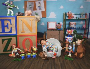 A little boy sleeps in a toddler chair