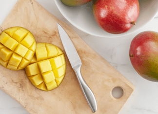 Image: A sliced mango on a wooden cutting board