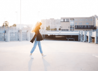 A woman walks across a street