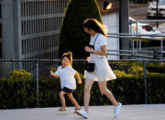 A mom running alongside her daughter
