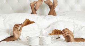 A couple enjoying breakfast in bed