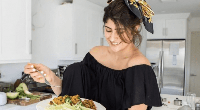 Michele holding a plate of homemade arroz con gandules