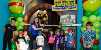 Several children participate in the ribbon cutting ceremony at Miami Children Museum's TMNT Secrets of the Sewer Exhibit