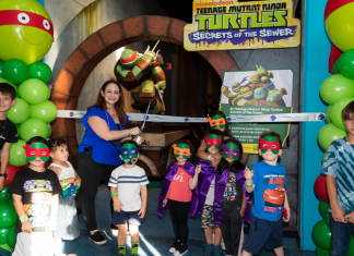 Several children participate in the ribbon cutting ceremony at Miami Children Museum's TMNT Secrets of the Sewer Exhibit
