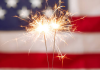 Image: Sparkler fireworks with an American flag in the background
