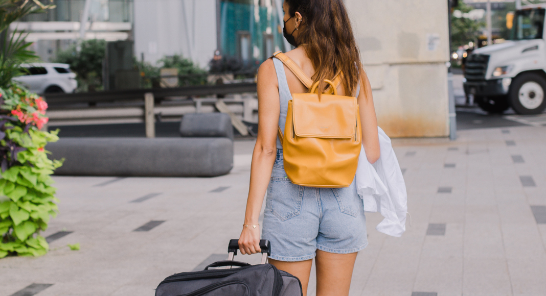 A girl walking with a suitcase