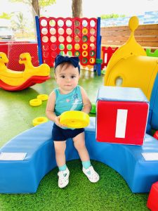 A toddler enjoying some outdoor play structures